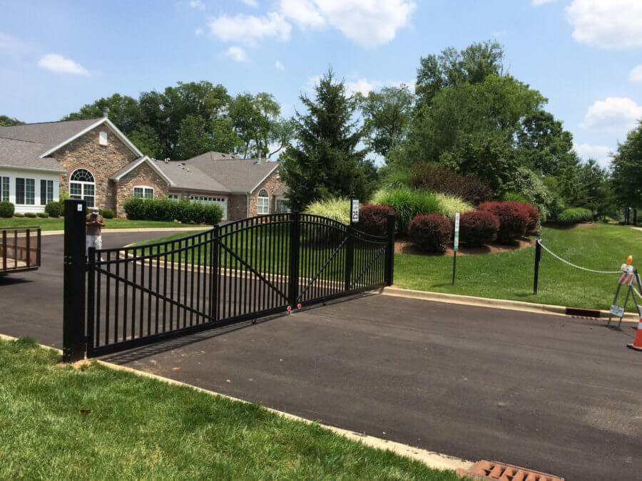 Black aluminum double drive gate across a driveway in Louisville, Kentucky