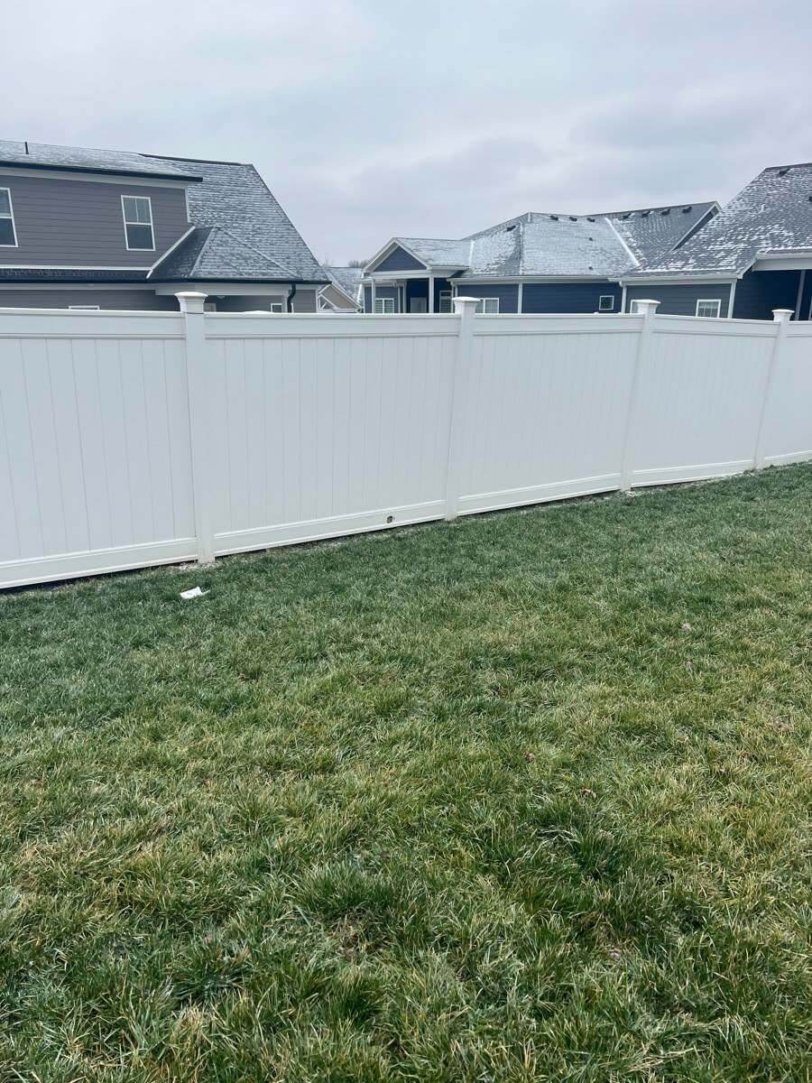White vinyl privacy fence enclosing a residential backyard in Louisville, Kentucky