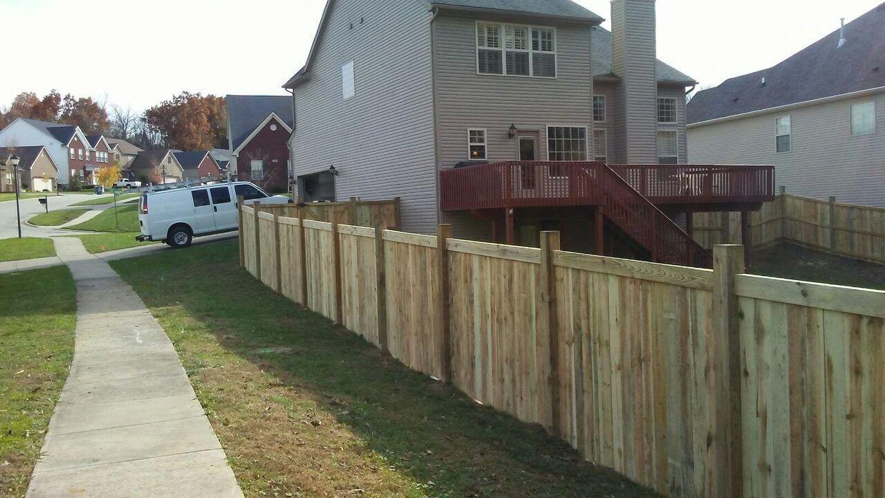 Six-foot dog-ear wood privacy fence along a backyard property line in Louisville, Kentucky