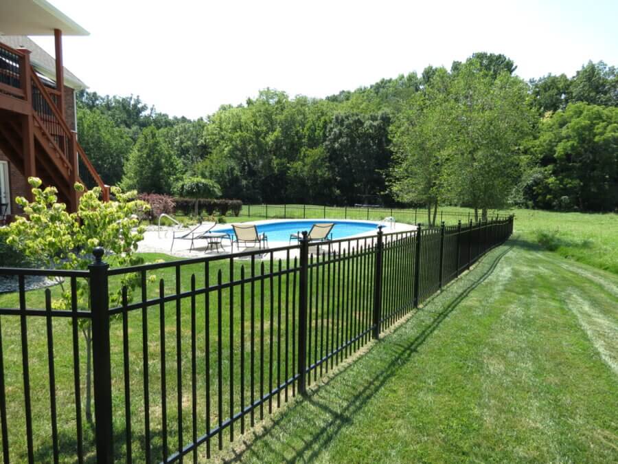 Black aluminum fence enclosing a backyard pool and lawn in Louisville, Kentucky