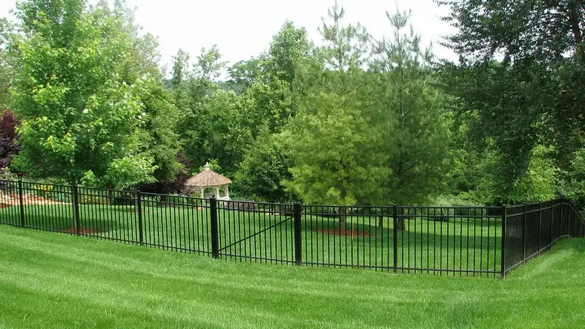 Black aluminum residential fence installed around a backyard lawn in Louisville, Kentucky