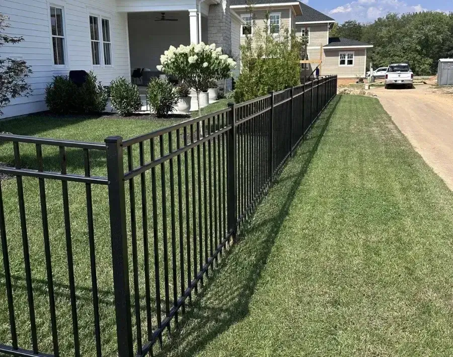 Black flat-top aluminum fence along a front lawn in Louisville, Kentucky