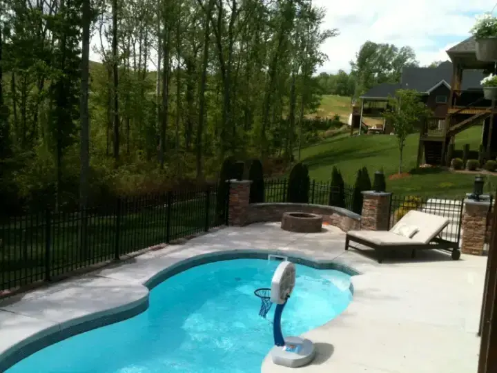 Black aluminum fence with finials enclosing an in-ground pool and patio in Louisville, Kentucky
