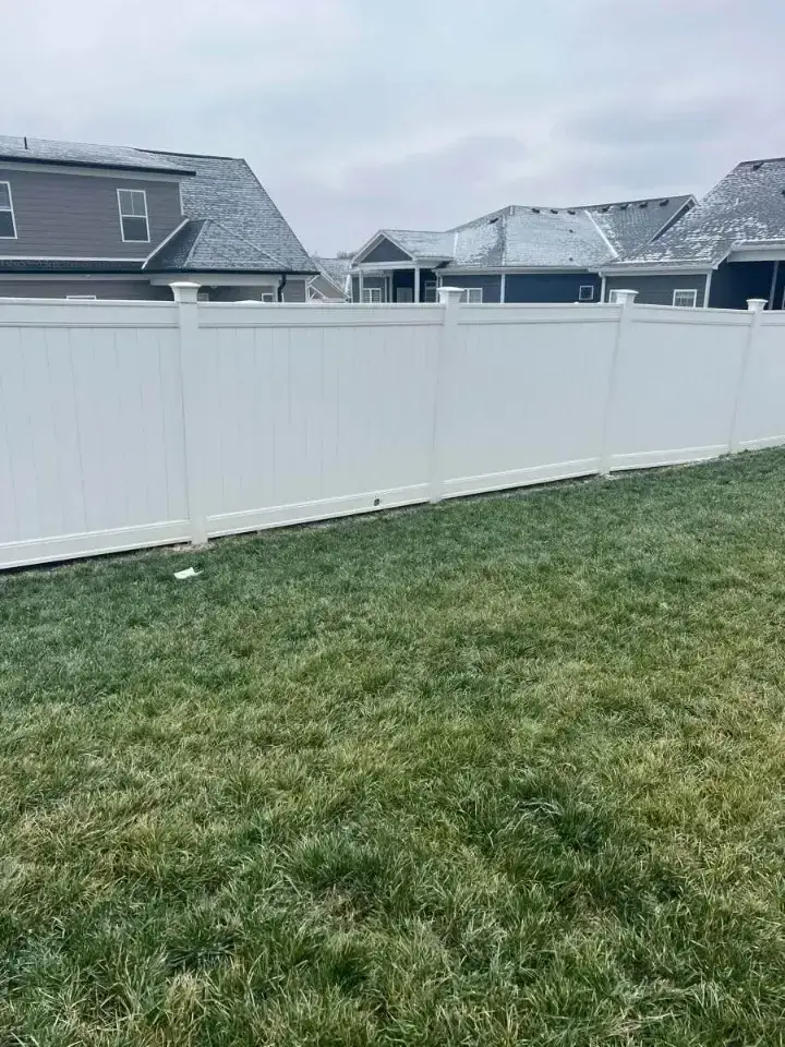 White vinyl privacy fence enclosing a residential backyard in Louisville, Kentucky