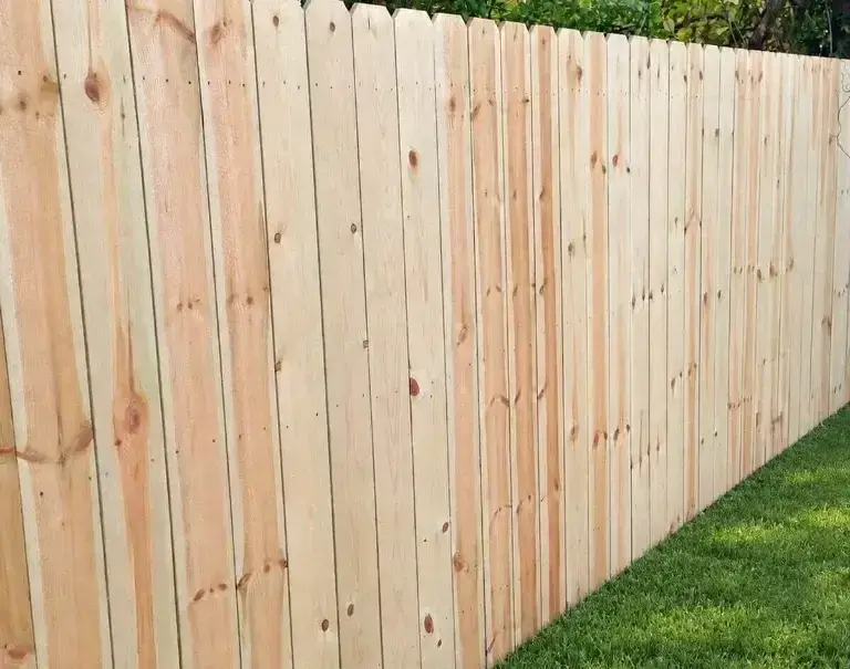 Six-foot wood privacy fence along a backyard property line in Louisville, Kentucky